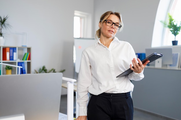 Confident middle aged business woman in the office