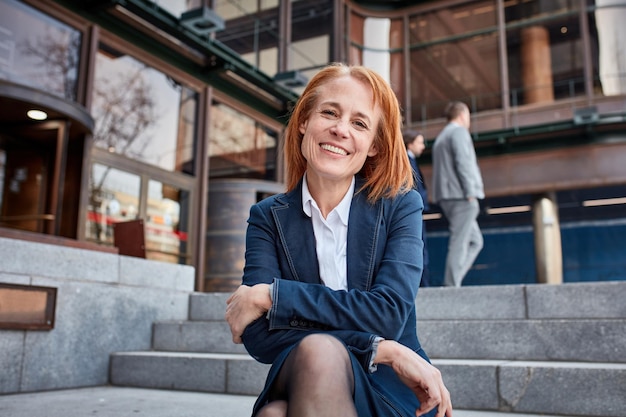 Confident middleaged businesswoman taking a welldeserved break