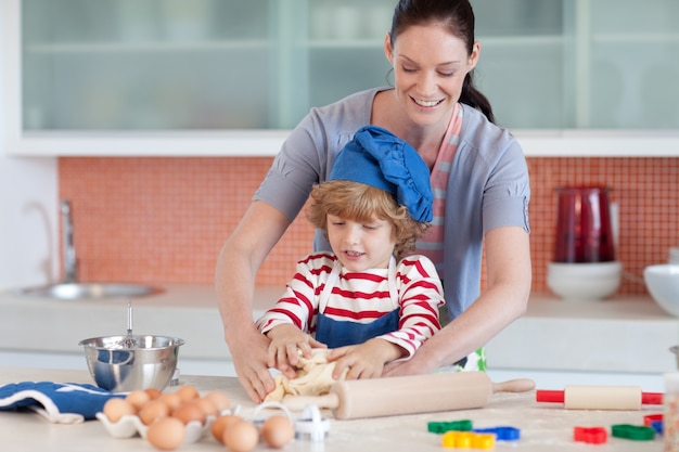 Confident mother and her son baking at home