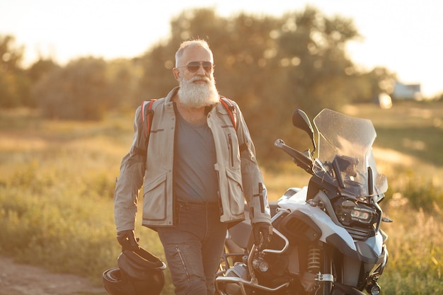 Confident old bearded biker man outdoor