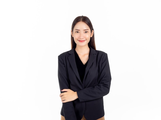 A confident pretty young Asian business woman in black suit with smiling, standing with her arms rolled up in a humble manner 