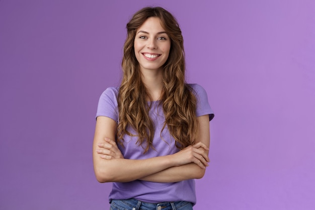 Photo confident professional skillful female photographer freelancer ready photo competition cross hands chest motivated assertive pose smiling broadly confident own abilities stand purple background.