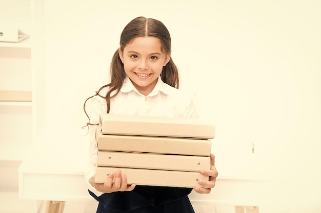 Confident pupil Towards knowledge small girl in school uniform lot of homework Get information kid learn and study hard back to school happy girl with workbook Education document folder