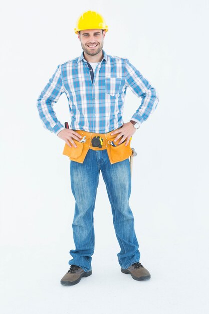 Confident repairman standing with hands on hips