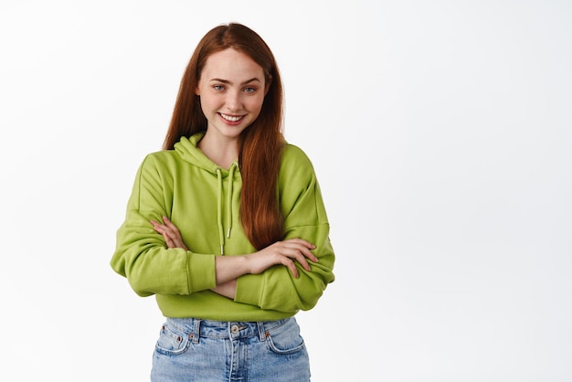 Confident and sassy redhead caucasian woman cross arms on chest selfassured smiling and looking with devious coy look have interesting idea white background