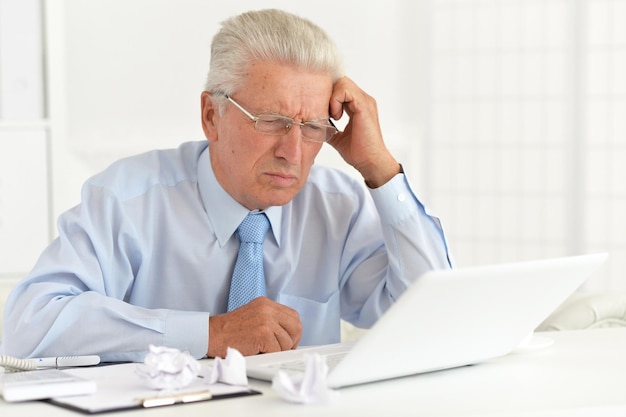 Confident senior businessman working in the office