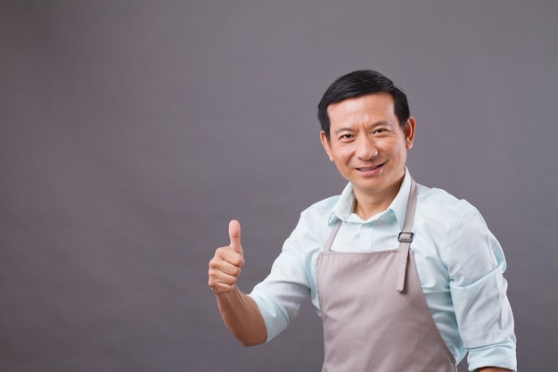 Confident shopkeeper giving thumb up, concept of successful small business owner, shop manager, entrepreneur studio isolated