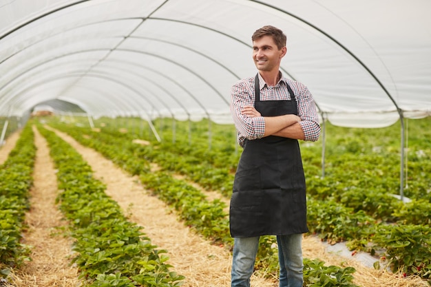 Confident small business owner in greenhouse