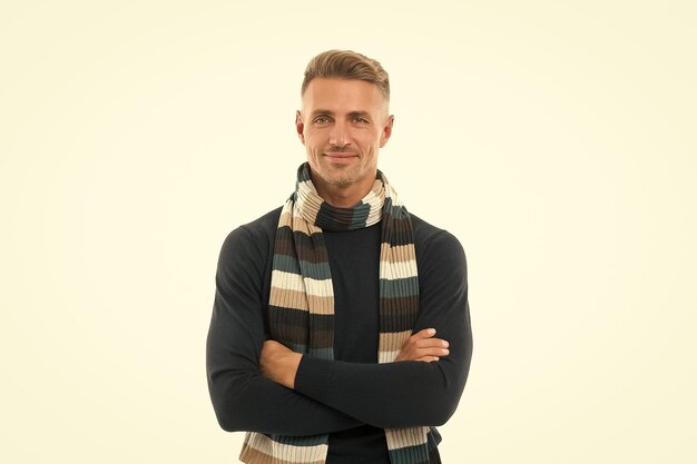 Confident smiling male in winter warm knitted scarf isolated on white warm clothing