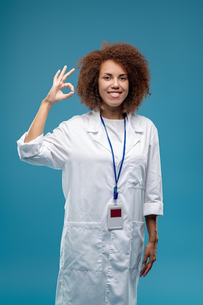 Confident smiling young woman in a lab coat