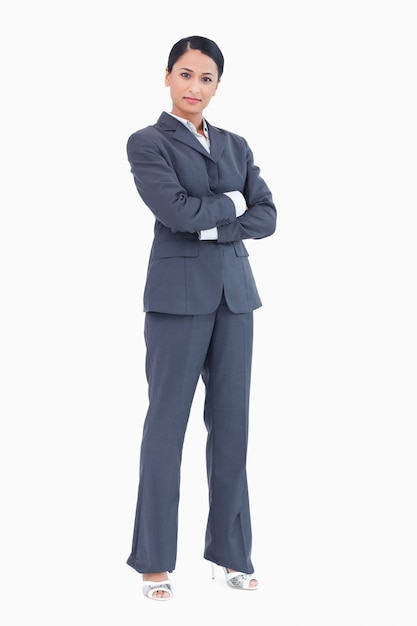 Confident standing businesswoman with arms folded