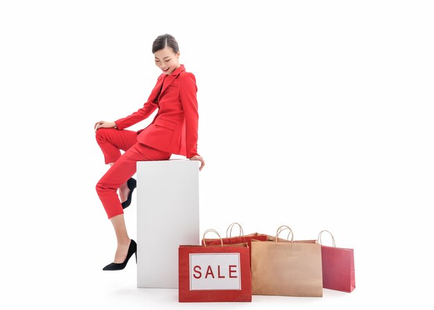 Confident stylish lady in red dress posing