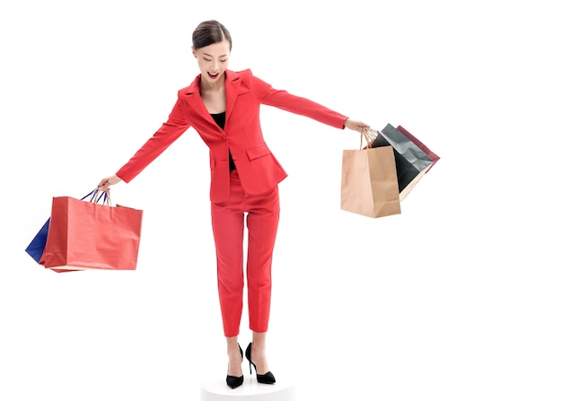 Confident stylish lady in red dress posing