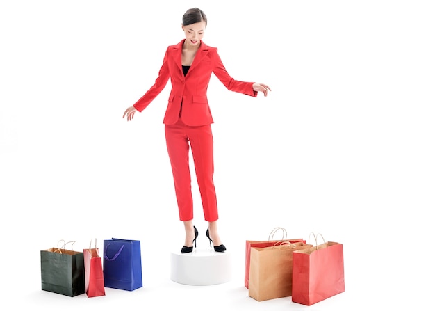 Confident stylish lady in red dress posing