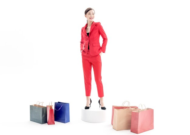 Confident stylish lady in red dress posing