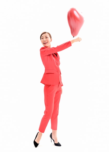 Confident stylish lady in red dress posing