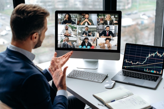 Confident successful businessman company boss stock investor having financial brainstorm with group of multiracial people by video conference discuss investments in the stock market risks