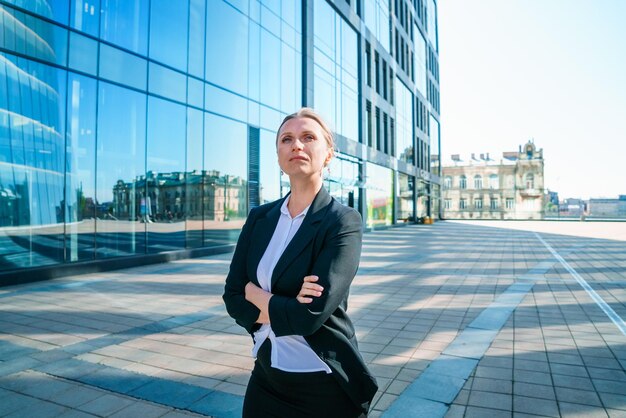 Confident successful smiling business woman entrepreneur in suit standing