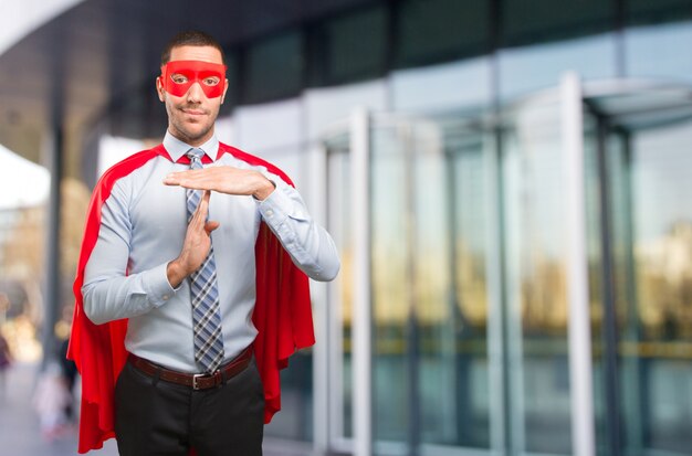 Confident super businessman doing a  time out gesture