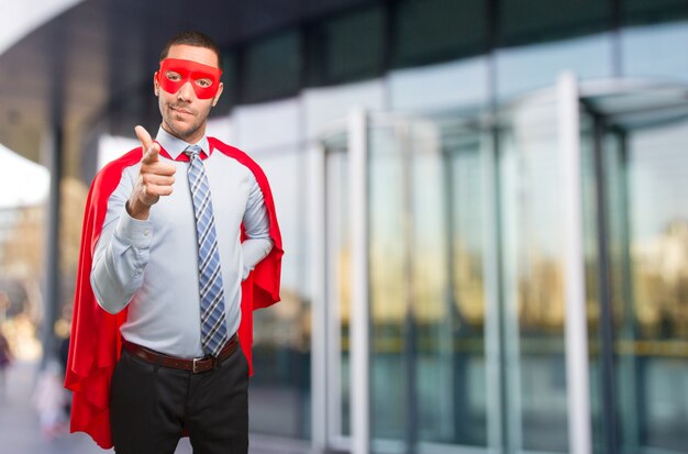 Confident super businessman pointing you