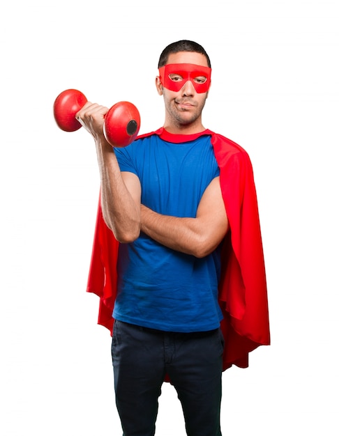 Confident superhero with a dumbbell