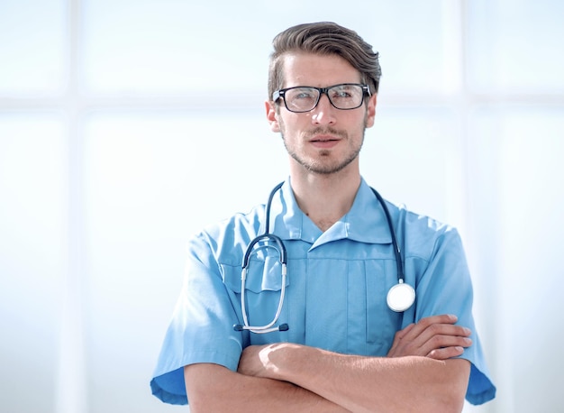 Confident surgeon man in blue uniform with a stethoscope around his neck