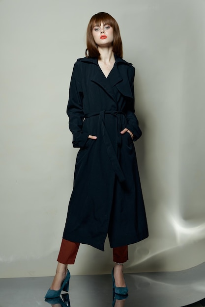 confident woman in a black coat and blue high heel shoe