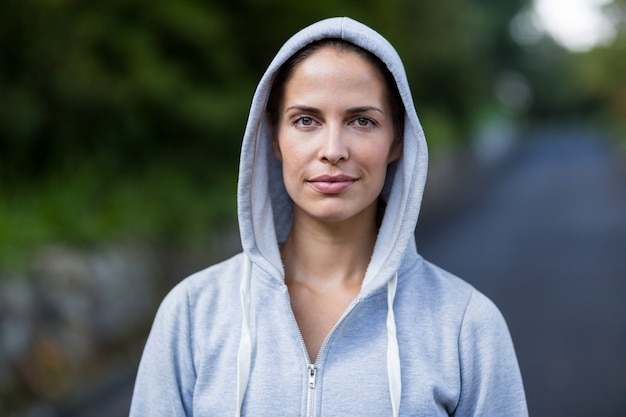 Confident woman wearing hooded sweater