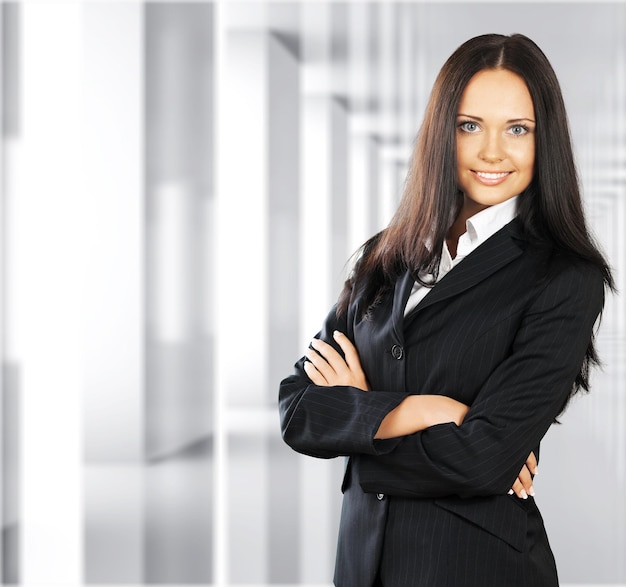 Confident woman with crossed hands on background