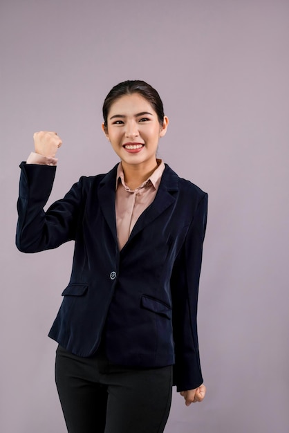 Confident young asian businesswoman in formal suit making hand gesture to indicate promotion or advertising with surprised face expression and gesture on isolated background Enthusiastic