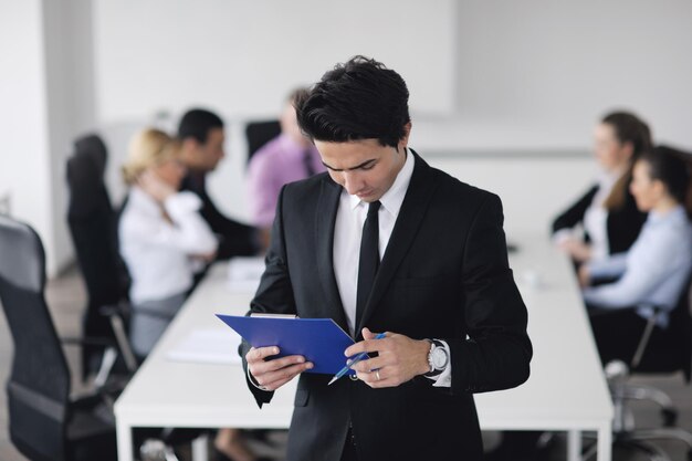 Confident young business man attending a meeting with his colleagues