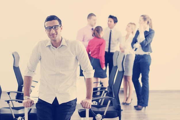 Confident young business man attending a meeting with his colleagues