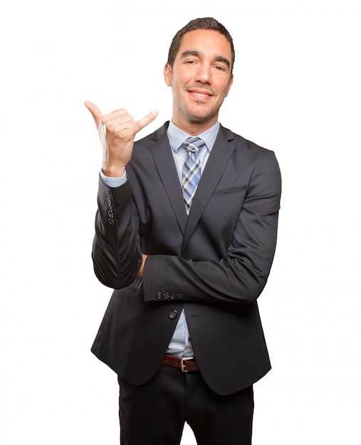 Photo confident young businessman doing a call gesture