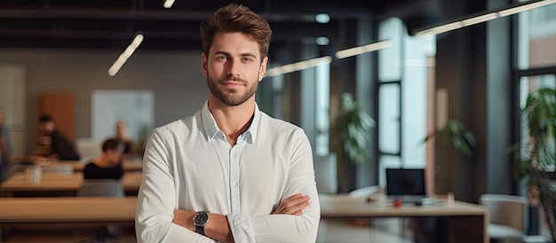 Confident young businessman posing in office looking at camera and smiling