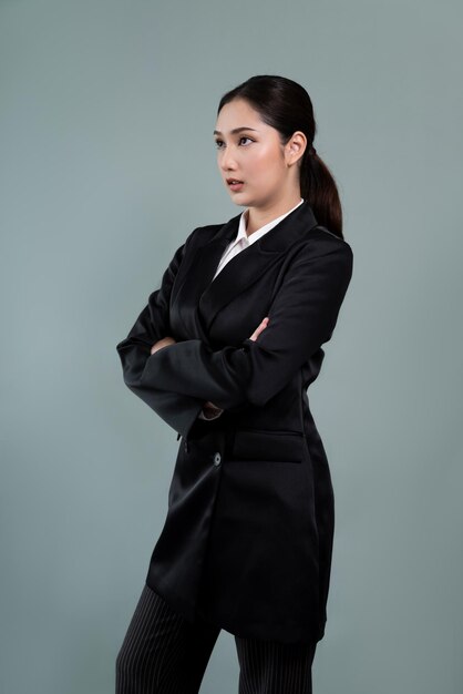 Confident young businesswoman stands on isolated background Enthusiastic