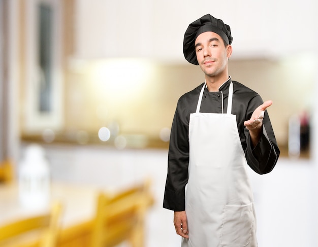 Confident young chef welcoming