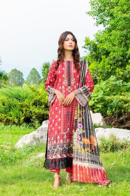 Confident Young Girl Wearing Traditional Trendy Designer Dress for Fashion Shoot in a Garden