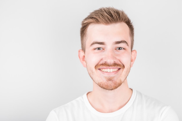 Confident young handsome man in white shirt