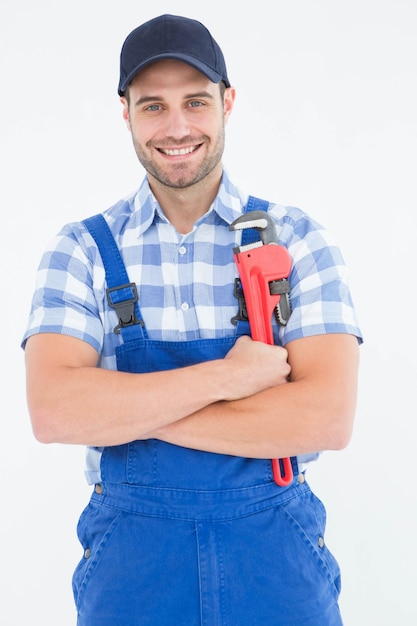 Confident young male repairman holding adjustable spanner