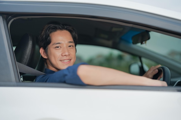 confident young man driving car