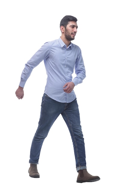 Confident young man in jeans striding forward