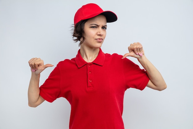 Confident young pretty delivery woman pointing at herself