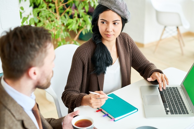 Confident Young Woman Leading Meeting