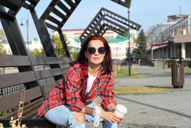 A confident young woman walks through the streets of the city a woman smiles and enjoys life