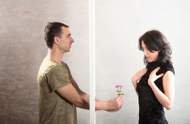 Conflict between man and woman standing on either side of a door