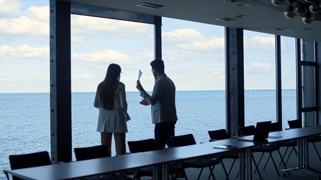 Conflicting man throwing papers go away in conference room Two managers argue