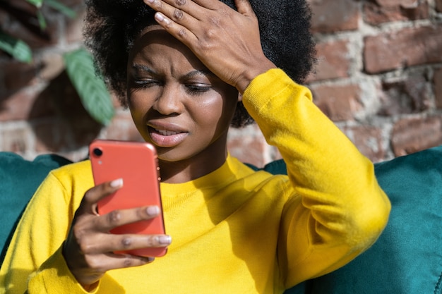 Confused AfroAmerican woman doing facepalm gesture