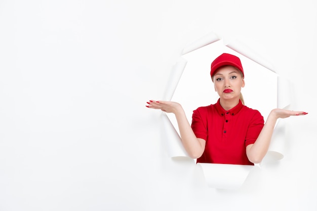 Confused female worker in red uniform on white