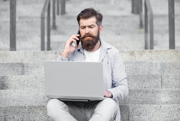 Confused guy has online video communication outdoor guy has online video communication