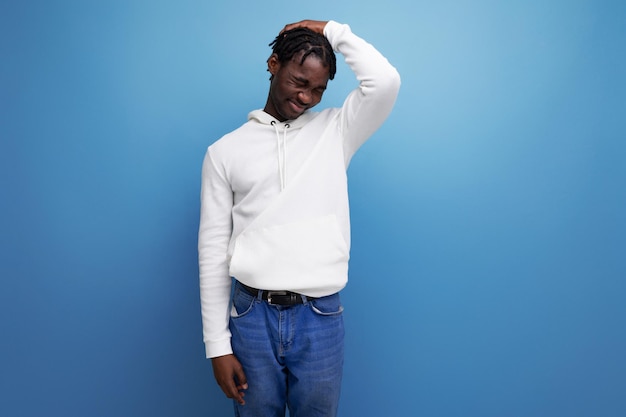 Confused man young brunet american man on blue isolated background